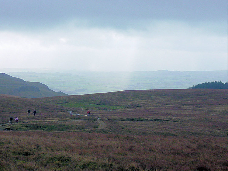 Walkers climbing Ingleborough from Gaping Gill