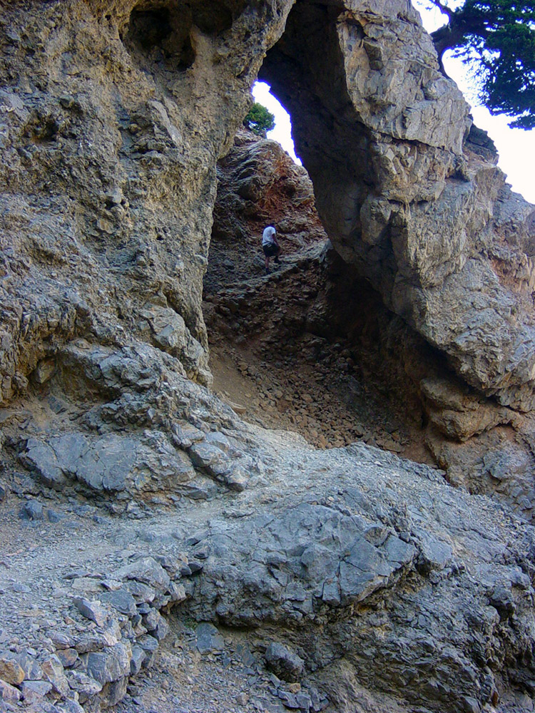 A natural archway shows the way up the mountain