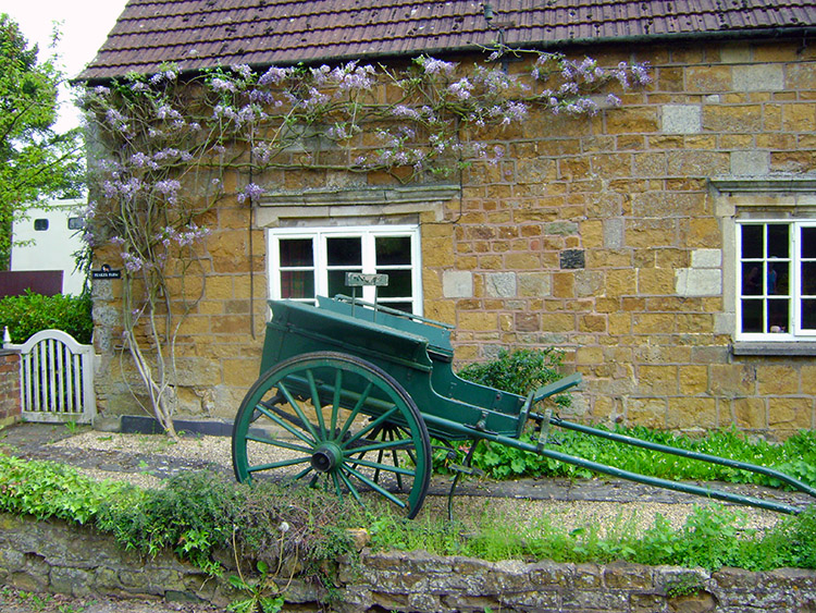 Old cart and wisteria in Burrough on the Hill