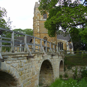 Medbourne pack horse bridge and church