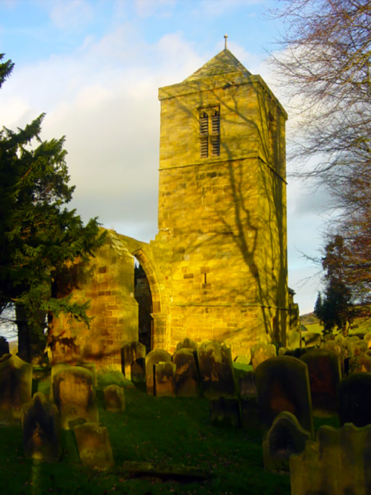 The tower houses two bells dated 1715