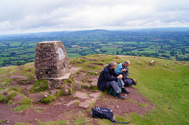 Enjoying a break on the summit of Ysgyryd Fawr