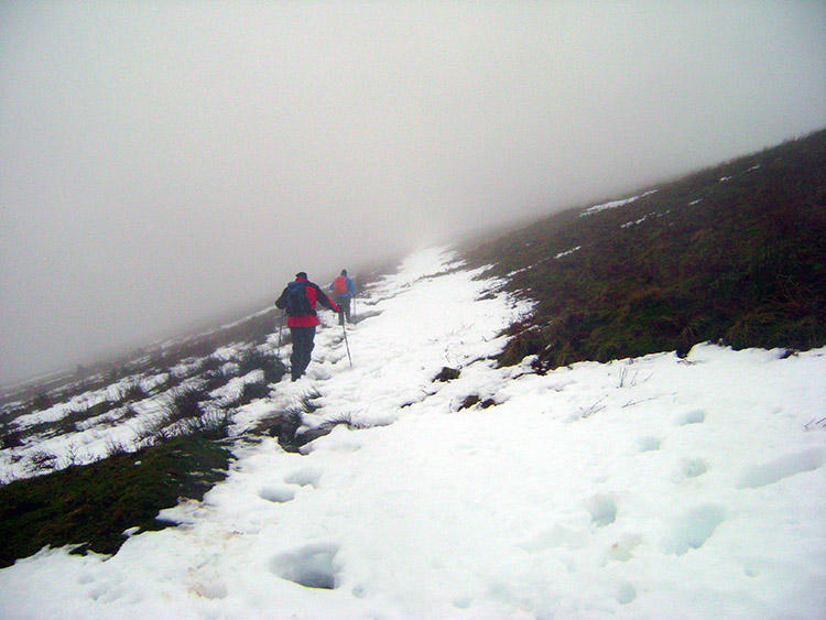 Trudging through melting snow into cloud