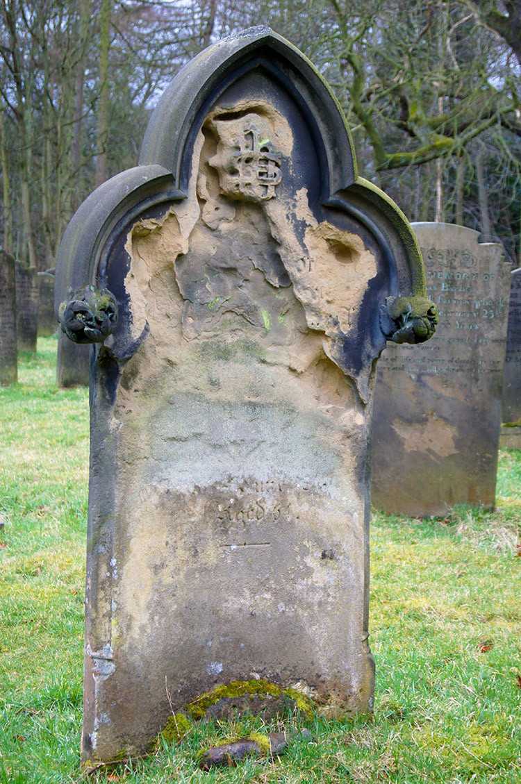 Weathered gravestone in Harewood Churchyard