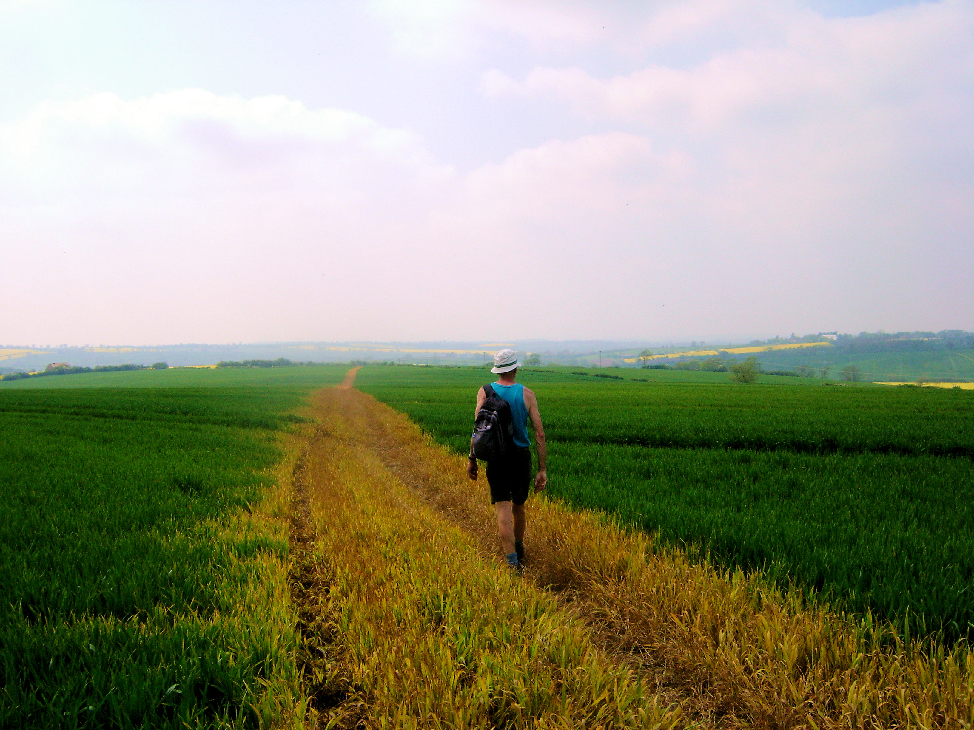 Ken crosses a large field on the way back