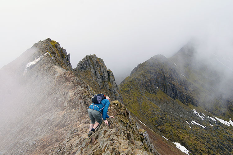 Adam begins crossing the top ridge of Crib Goch