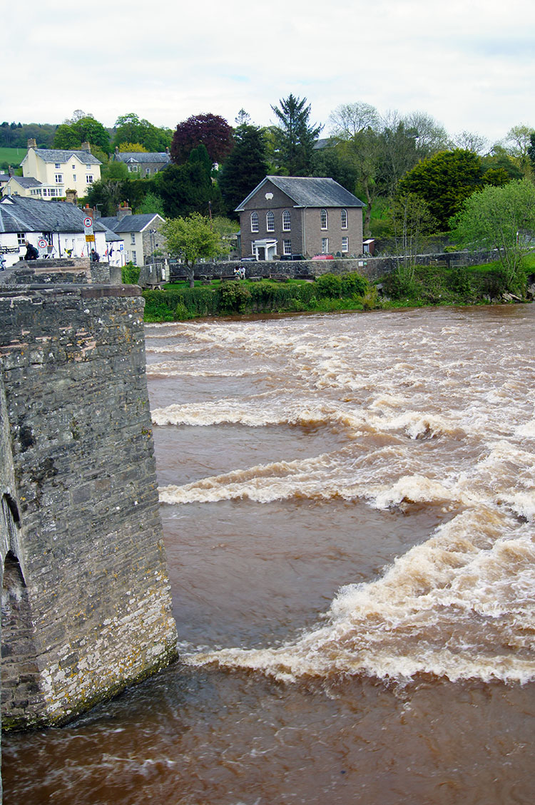 After rain the Usk surges under Crickhowell Bridge