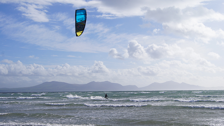 View across Llanddwyn Bay to Snowdonia